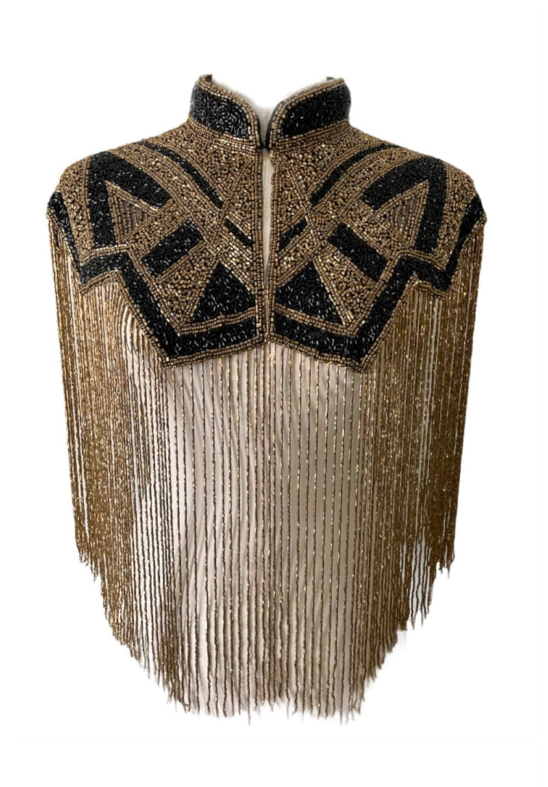 L'Jai Amor Axis Line Cape displayed on a hanger, featuring elegant fabric and stylish design for a layered fashion look.