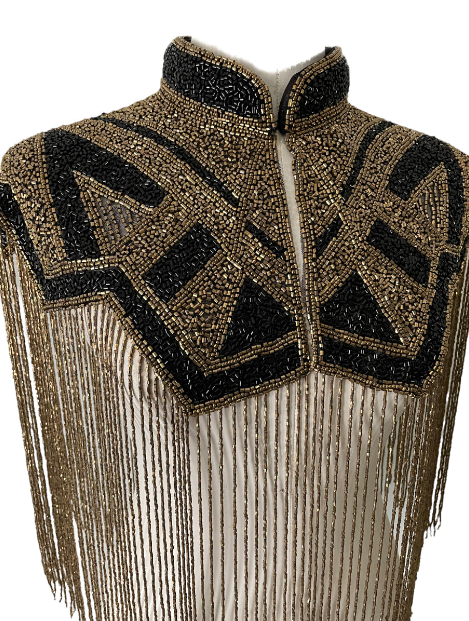 L'Jai Amor Axis Line Cape draped over a mannequin, showcasing its flowing fabric and stylish design.