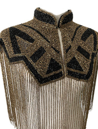 L'Jai Amor Axis Line Cape draped over a mannequin, showcasing its flowing fabric and stylish design.