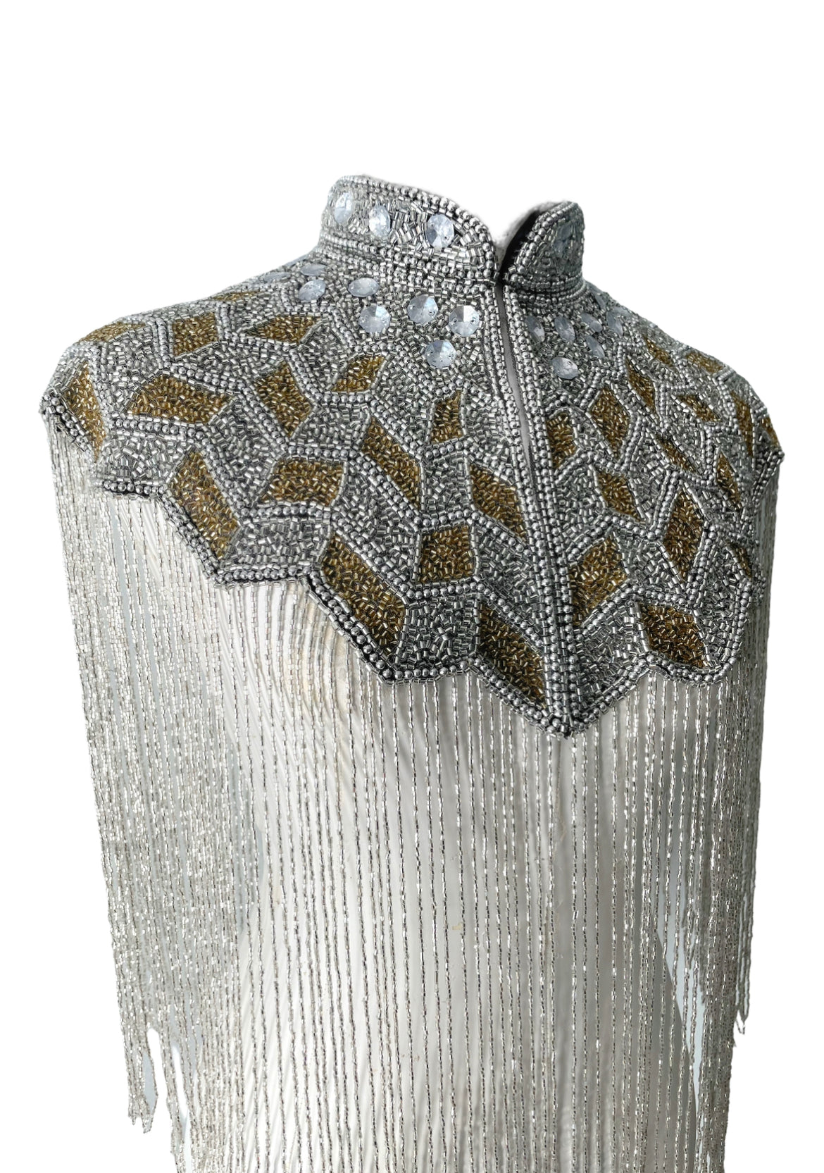 L'Jai Amor Gilded Halo Cape displayed on a mannequin with intricate gold detailing and flowing fabric.
