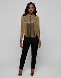 L'Jai Amor Golden Line Cape, elegant gold-colored cape with intricate detailing, draped over a mannequin for a stylish look.
