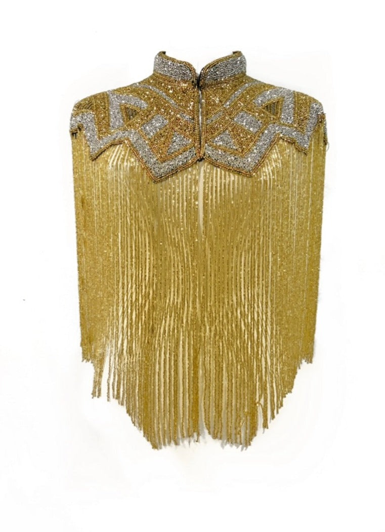 L'Jai Amor Golden Line Cape displayed on a mannequin, showcasing its luxurious fabric and elegant golden accents.