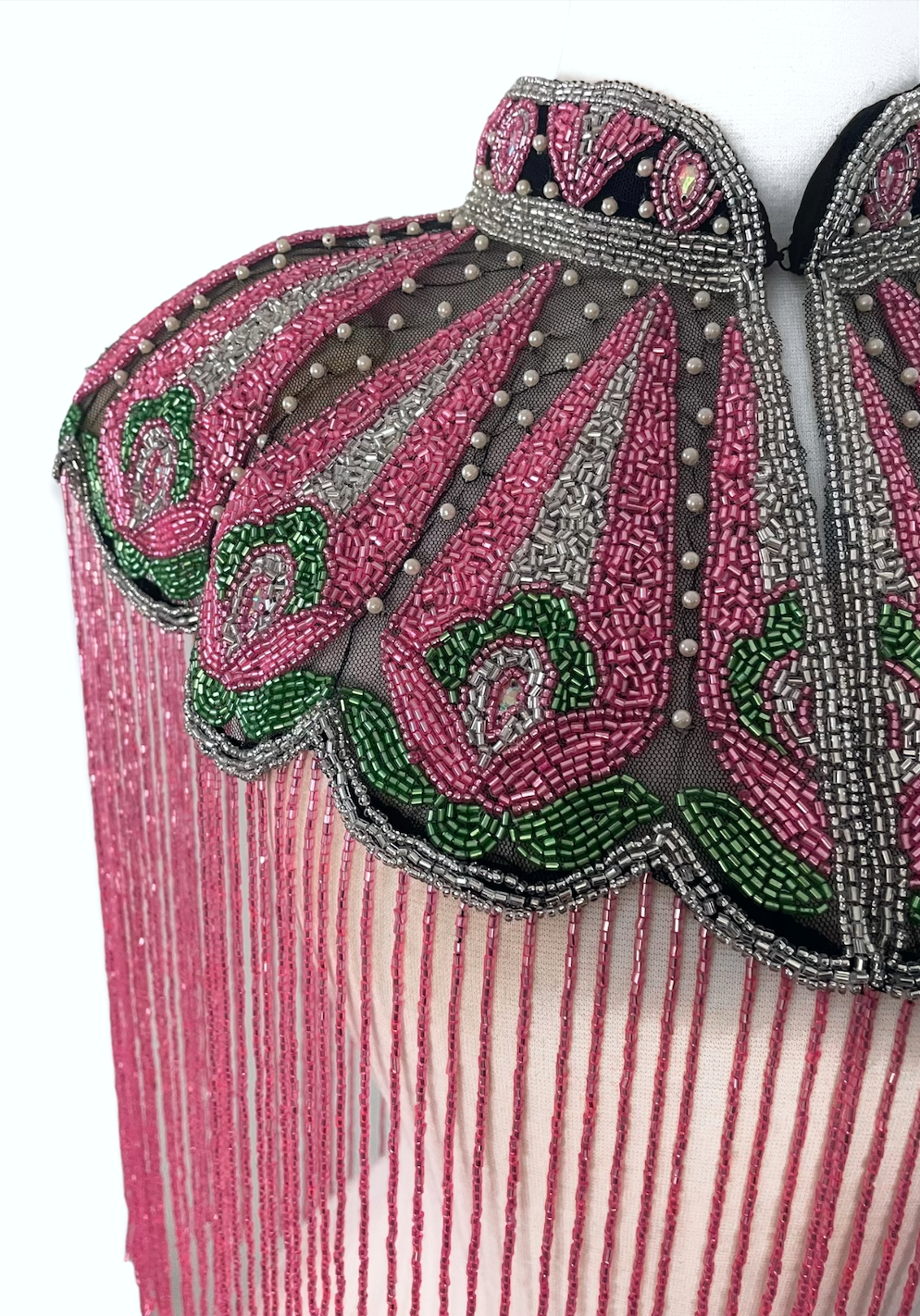 L'Jai Amor Ivy Rose Cape displayed with intricate floral embroidery and flowing fabric, perfect for elegant outdoor wear.