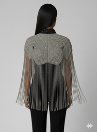 L'Jai Amor Liquid Steel Cape displayed on a mannequin, showcasing its sleek, metallic design and flowing fabric.