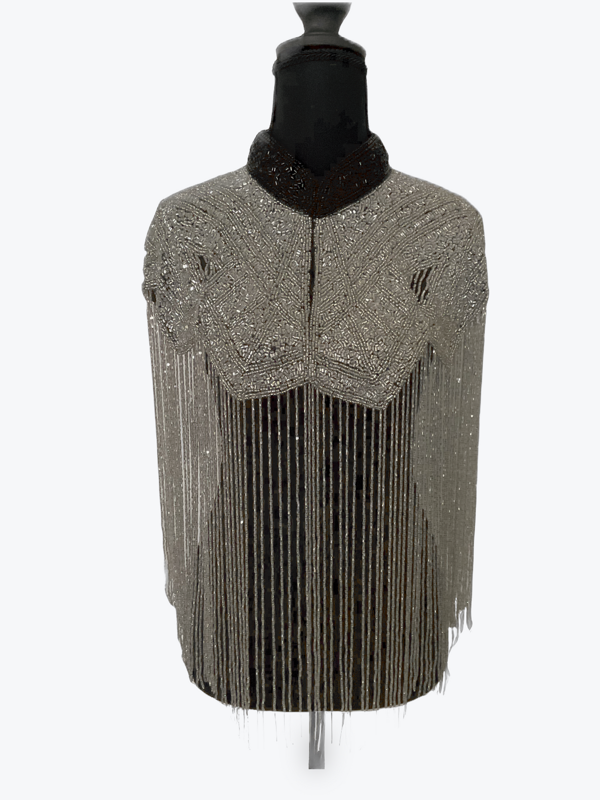 L'Jai Amor Liquid Steel Cape displayed on a mannequin, showcasing its sleek metallic design and stylish cape silhouette.