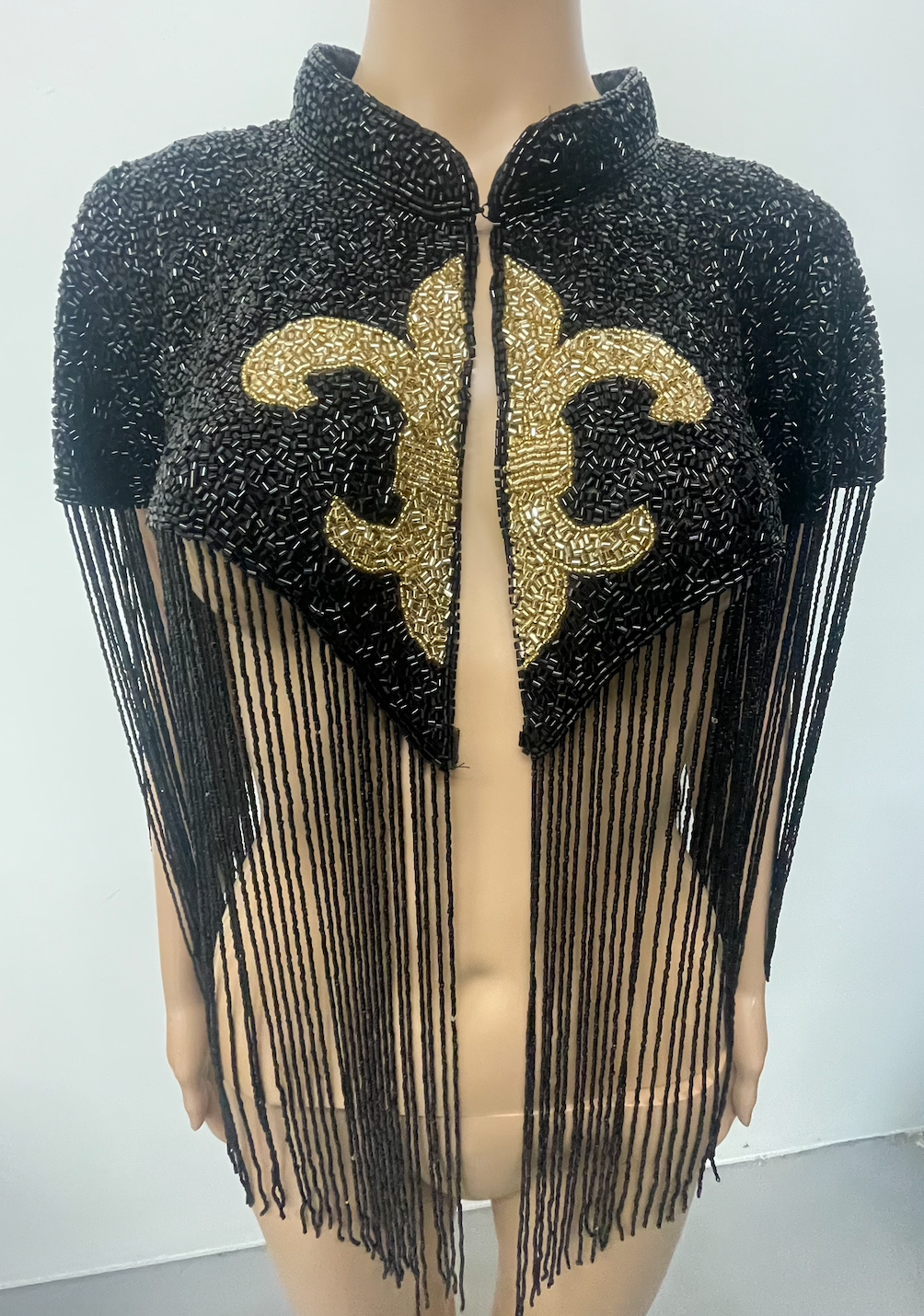 L'Jai Amor Maison Fleur Cape displayed with floral embroidery, flowing fabric, and elegant drape, showcasing its stylish design.