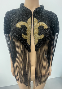 L'Jai Amor Maison Fleur Cape displayed with floral embroidery, flowing fabric, and elegant drape, showcasing its stylish design.