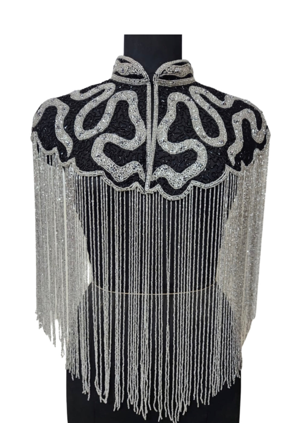 L'Jai Amor Noir Sovereign Cape draped elegantly, showcasing luxurious black fabric with intricate detailing and regal style.