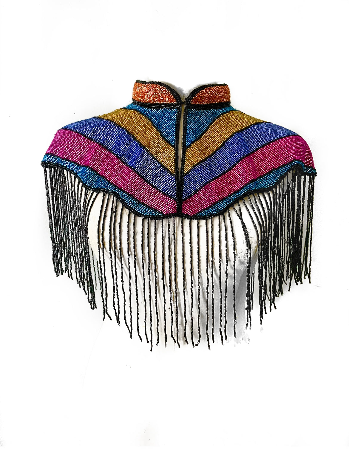 L'Jai Amor Solidarity Cape in vibrant fabric, draped with detailed craftsmanship and colorful design, displayed on a neutral background.