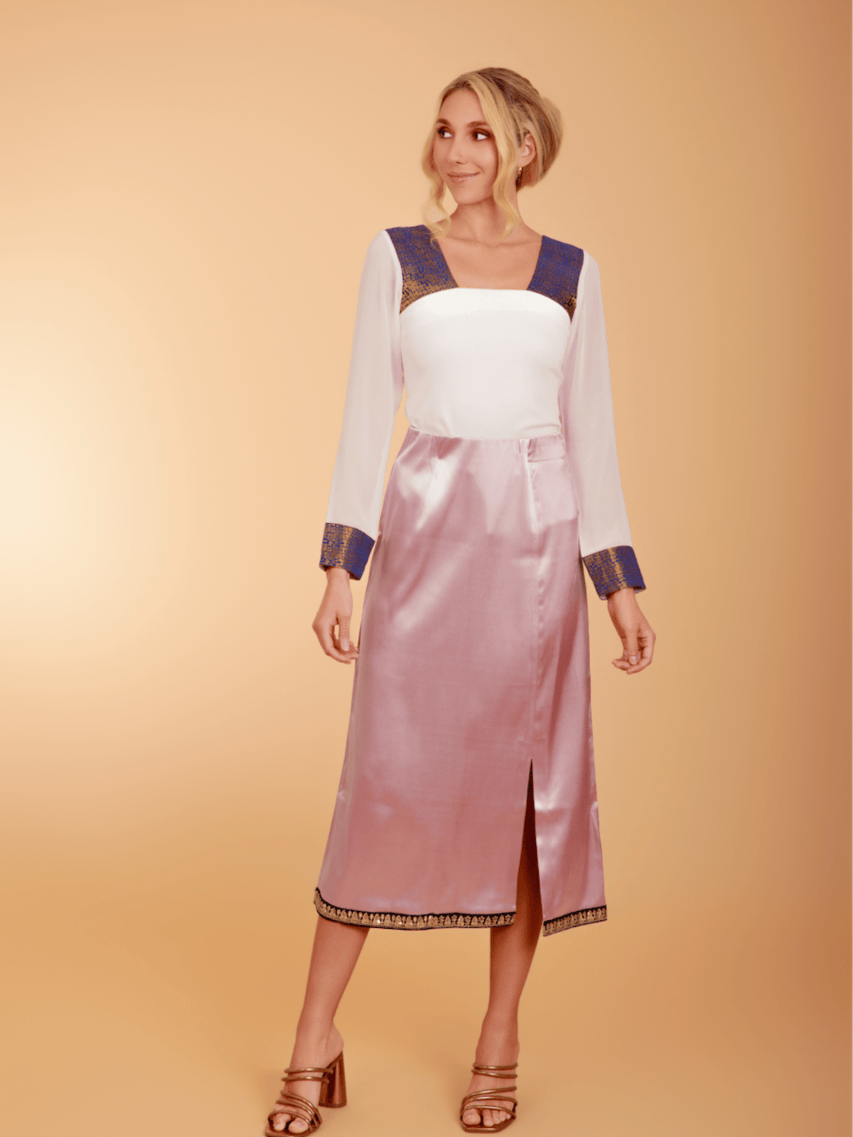 White top paired with La' Agra The Belle Skirt in purple, stylish bottoms perfect for casual or dressy occasions.