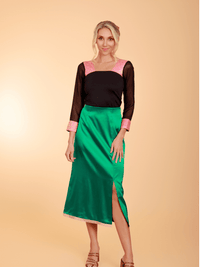 Black top paired with a green skirt from La' Agra's The Belle Skirt bottoms collection.