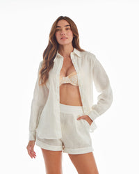White floral blouse by LA'AVANA featuring a lightweight fabric and a relaxed fit, shown on a hanger.