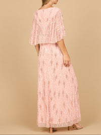 Emerald green beaded gown with a matching half cape by Lara New York, elegant dress perfect for formal occasions.