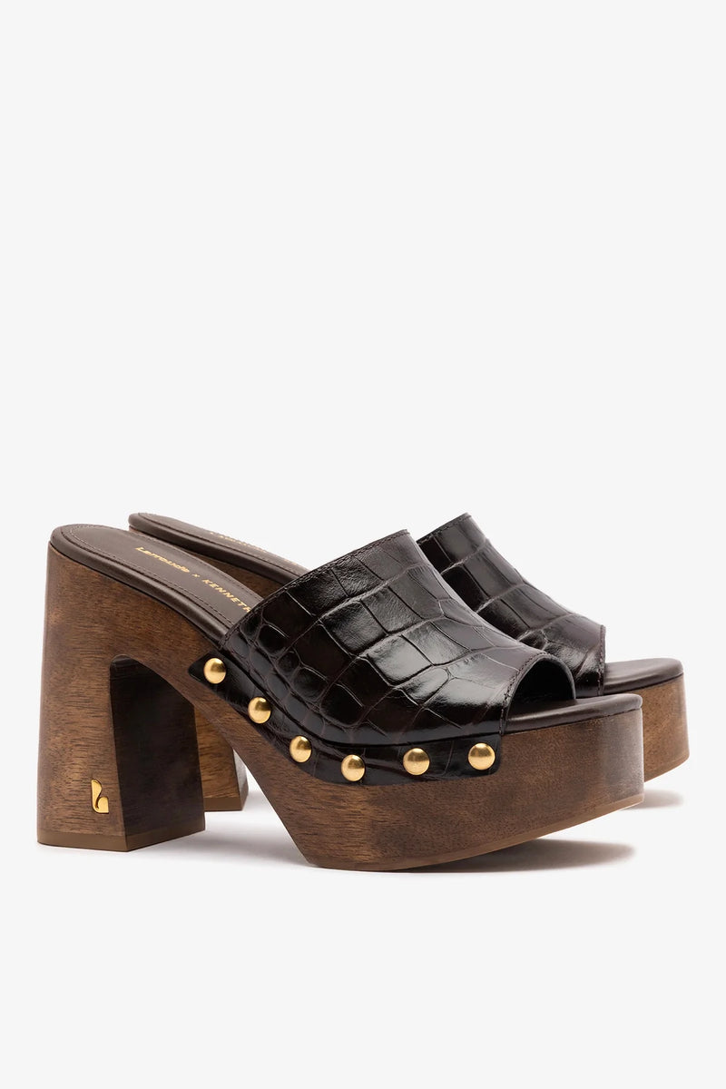 Dark oak croco leather mule by Larroude in collaboration with Kenneth Cole, featuring a sleek slip-on design and textured crocodile pattern.