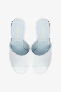 Larroudé x Kenneth Cole Mule Maya in glossy patent leather, stylish slip-on shoe with a sleek design and pointed toe.