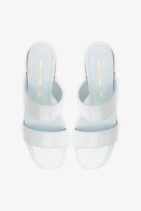 Larroude x Kenneth Cole Sandal Maya in glossy patent leather with sleek straps and a modern design.