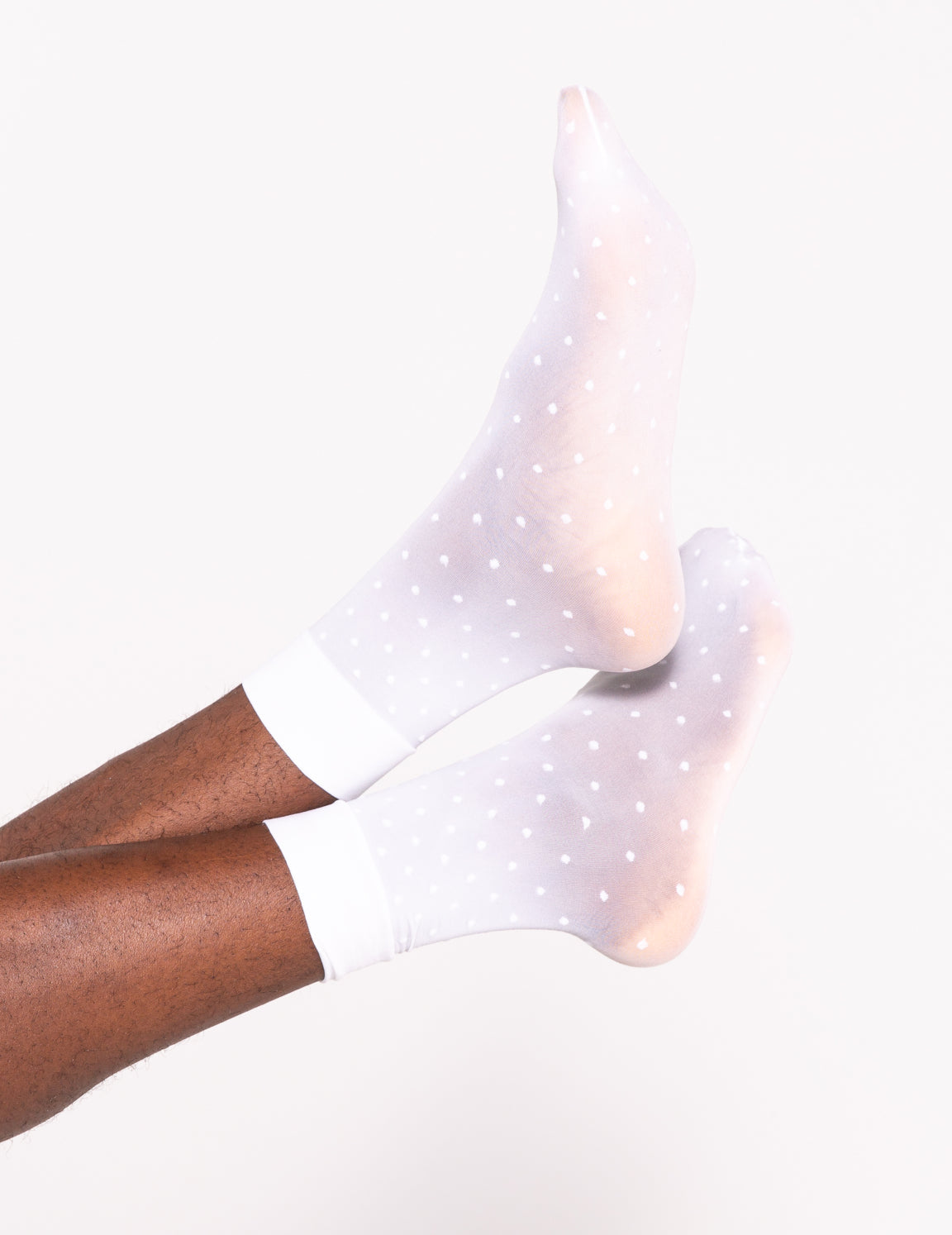 Close-up of a petite white dots pattern fabric by Les Belles Co, featuring small white dots on a neutral background.