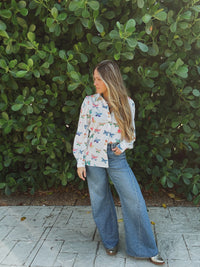 Lil Bee's Bohemian butterfly button-up blouse featuring eye-catching face and butterfly design, casual and stylish women's apparel.
