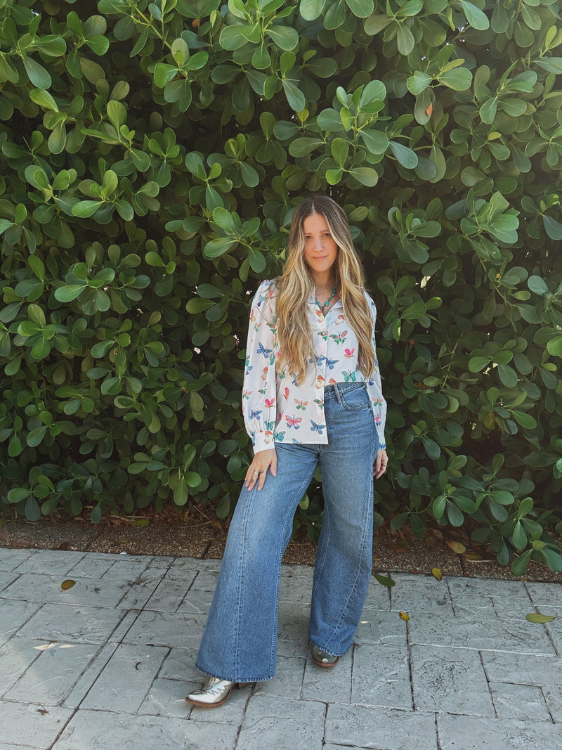 Lil Bee's Bohemian butterfly button-up blouse featuring eye and face designs, lightweight and stylish women's apparel.