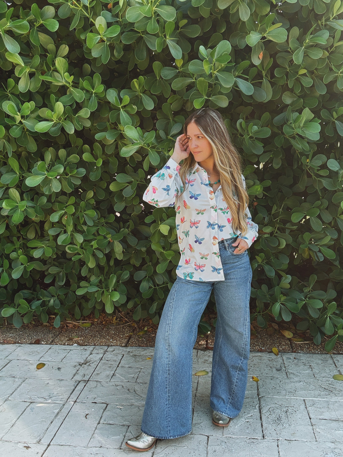Lil Bee's Bohemian butterfly button-up blouse with eye and face design, featuring a relaxed fit and lightweight fabric.
