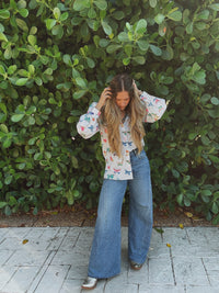 Lil Bee's Bohemian butterfly button-up blouse featuring eye and face graphic design, lightweight fabric, and casual boho style.