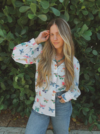 Lil Bee's Bohemian butterfly button-up blouse featuring eye and face design, casual apparel with vibrant boho style.