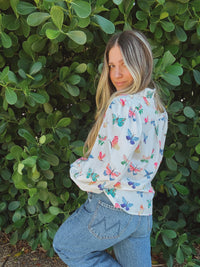 Lil Bee's Bohemian butterfly button-up blouse featuring eye-themed design, lightweight fabric, and stylish collar detail.