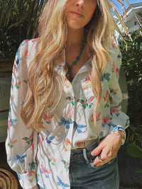 Lil Bee's Bohemian butterfly button-up blouse featuring eye-catching eye and face design on lightweight fabric.