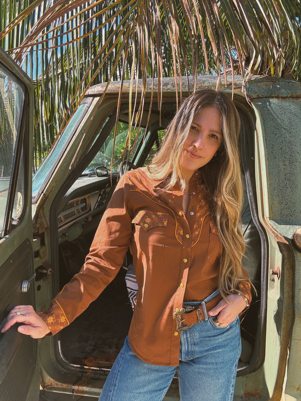 John Wayne Western brown pearl snap button-up top by Lil Bee's Bohemian, featuring a casual Western style shirt with pearl snap buttons.