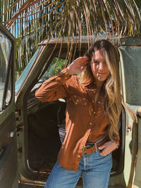 John Wayne Western pearl snap button-up top in brown by Lil Bee's Bohemian, featuring a classic western shirt design with pearl snap buttons.