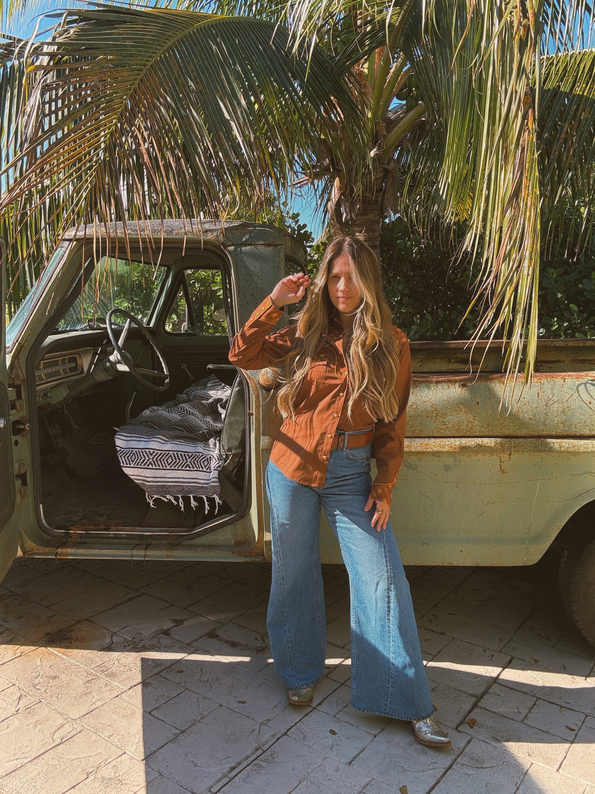 John Wayne Western pearl snap button-up top in brown by Lil Bee's Bohemian, featuring a classic Western style and pearl snap details.