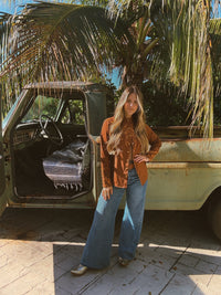 John Wayne Western pearl snap button-up top in brown by Lil Bee's Bohemian, showing front view with collar and pearl buttons.