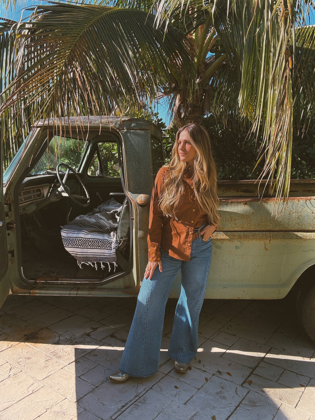 John Wayne western pearl snap button-up top in brown by Lil Bee's Bohemian, showing the stylish Western-inspired shirt with pearl snap buttons.