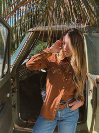Brown John Wayne Western pearl snap button-up top by Lil Bee's Bohemian, featuring classic Western style and detailed pearl snap buttons.