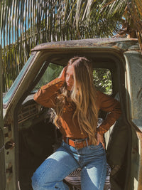 Brown John Wayne Western pearl snap button-up top by Lil Bee's Bohemian, featuring classic Western style and pearl snap details.