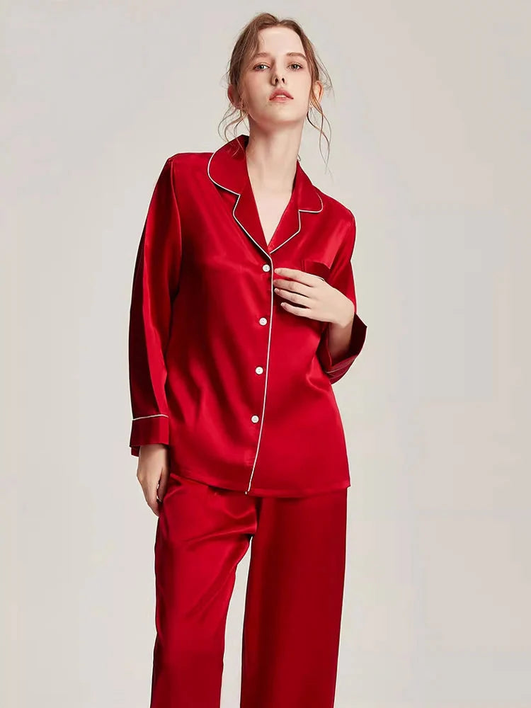 Loran women's white silk pajama set with long sleeve top and matching bottoms, elegant and comfortable nightwear for women.