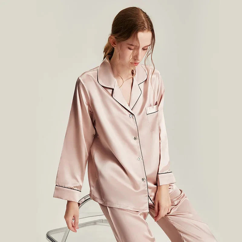 Women's white silk pajama set with long sleeves by Loran, featuring a comfortable and elegant nightwear design.