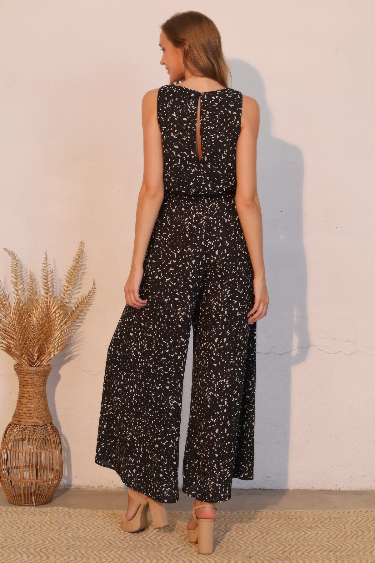 LORNEA Ink Spot Sleeveless Bubble Jumpsuit with round neckline and relaxed fit, displayed on a hanger against a neutral background.