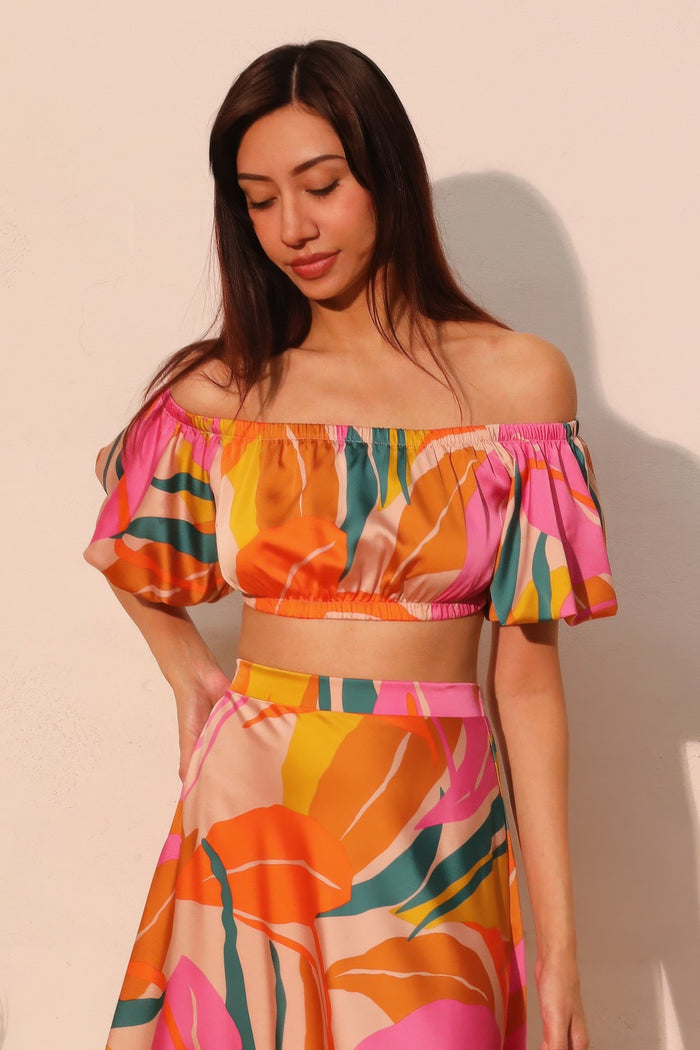 LORNEA Isla Tropical satin bubble sleeve crop top in vibrant tropical print, featuring puffed satin sleeves and a fitted crop design.