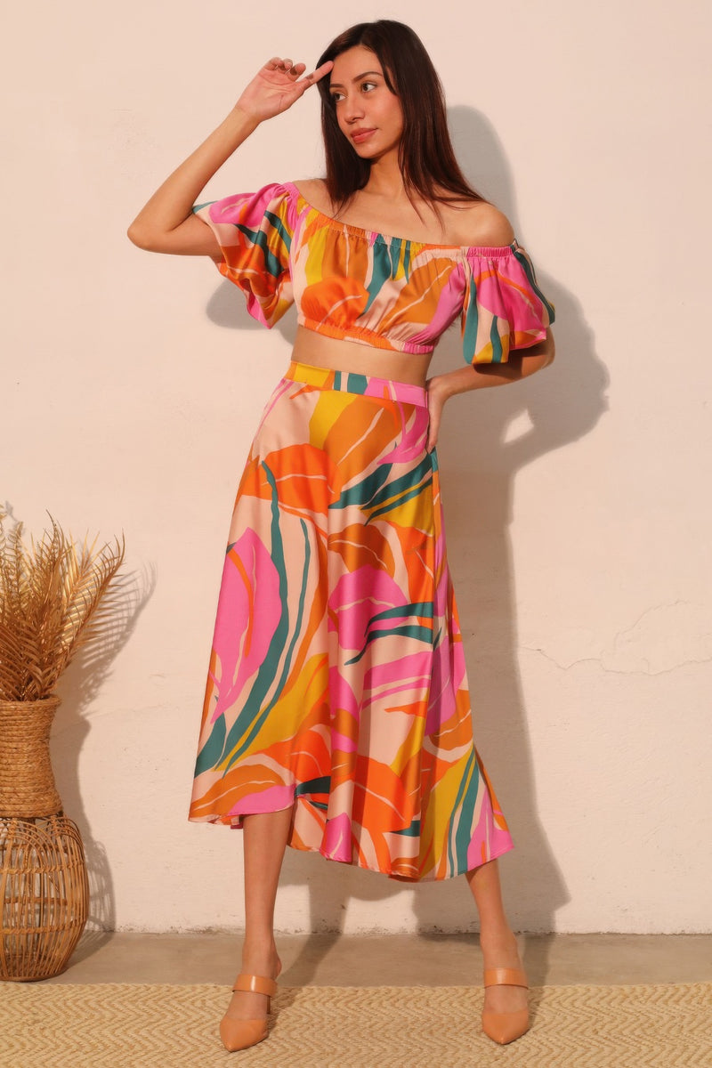 LORNEA Isla Tropical satin bubble sleeve crop top in vibrant tropical print with puffed sleeves and cropped fit.
