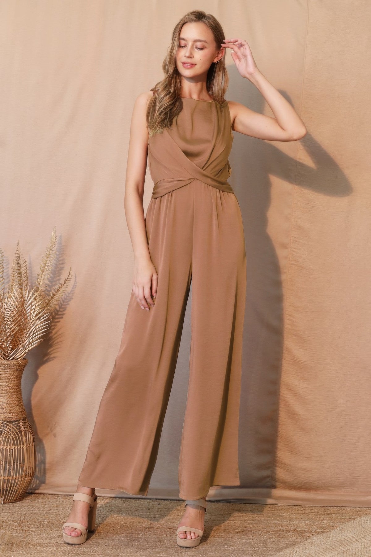 LORNEA washed poly silk twist front jumpsuit with sleeveless design and wide-leg pants, shown on a model.
