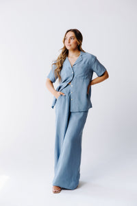 Margo Paige washable silk wide-leg pants displayed flat, showcasing their smooth fabric and relaxed fit.