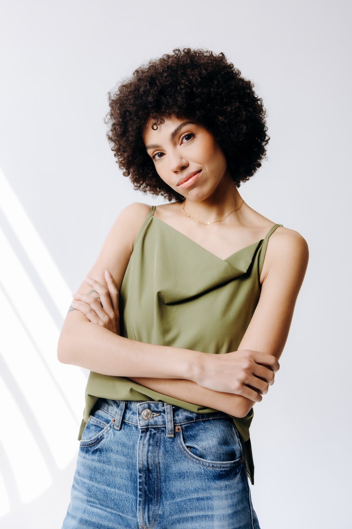 Margo Paige cowl neck camisole in soft fabric with draped neckline, sleeveless design, and slim fit for stylish layering.