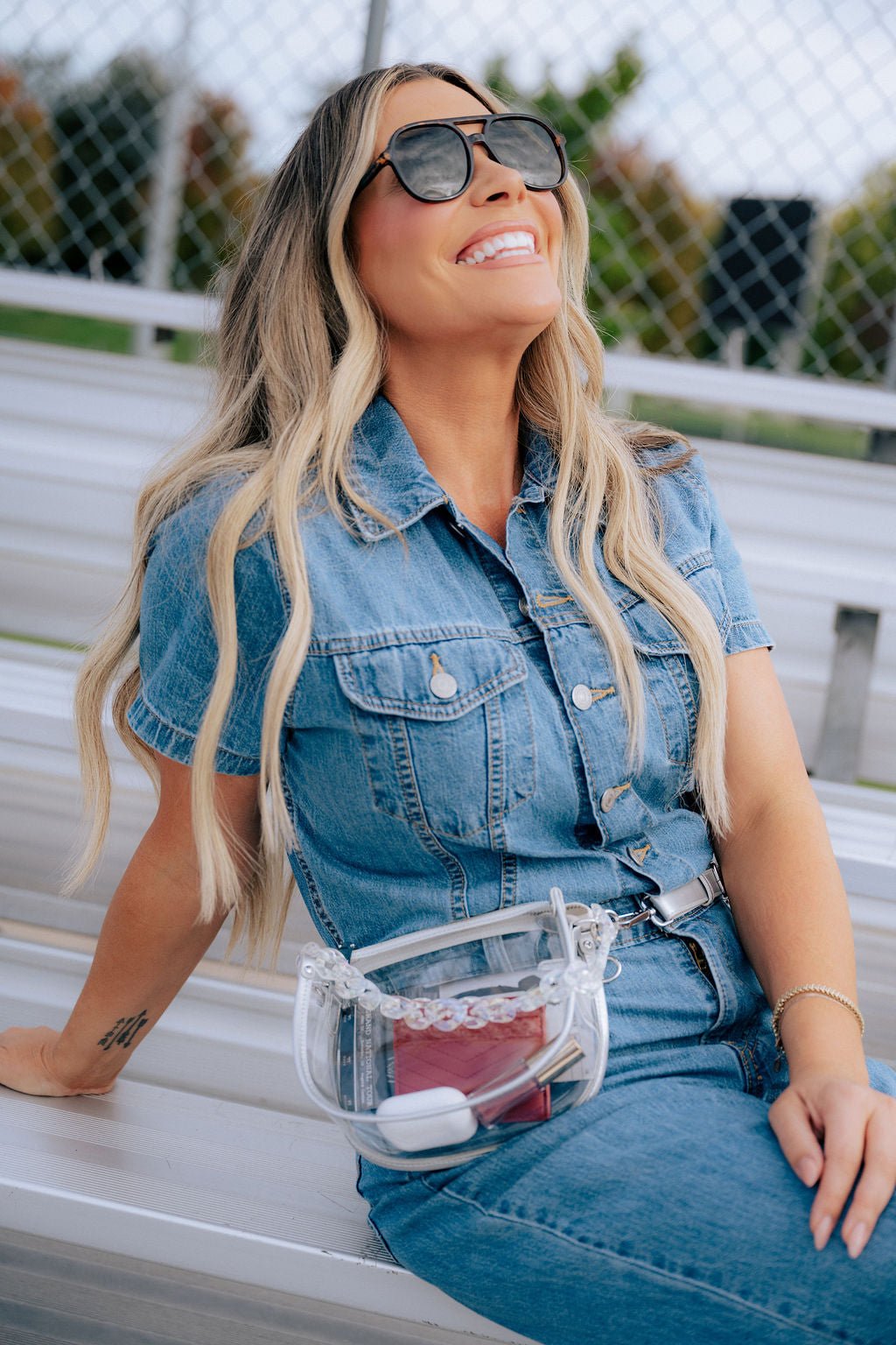 Margo Paige clear belt handbag with adjustable strap and spacious interior, stylish accessory for casual or trendy outfits.