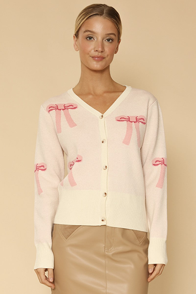 Miss Sparkling cropped knit bow cardigan, close-up of the front showing the bow detail and textured knit fabric.