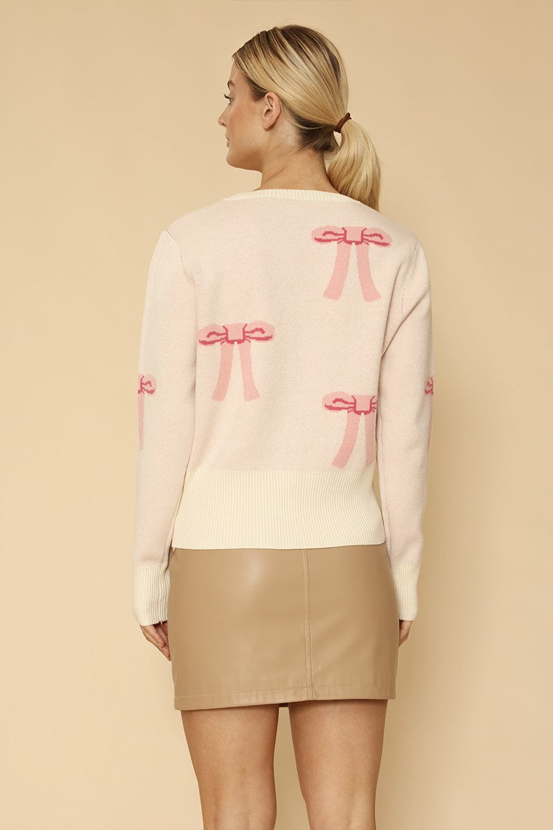 Miss Sparkling cropped knit bow cardigan featuring a cozy knit fabric and a charming bow detail at the front.