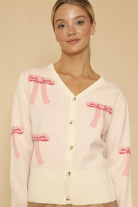 Miss Sparkling cropped knit bow cardigan, soft pastel-colored knit with a bow detail, perfect for casual and stylish outfits.