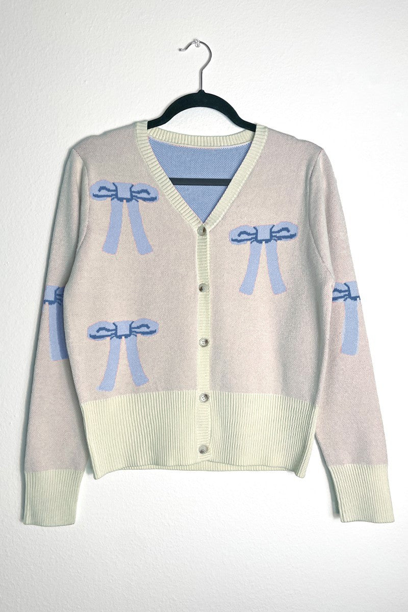 Miss Sparkling cropped knit bow cardigan featuring a soft knit fabric and a charming bow detail at the front.