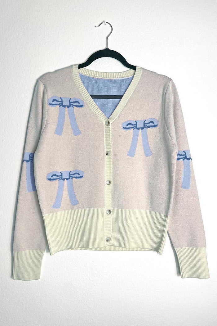 Miss Sparkling cropped knit bow cardigan featuring a soft knit fabric and a charming bow detail at the front.