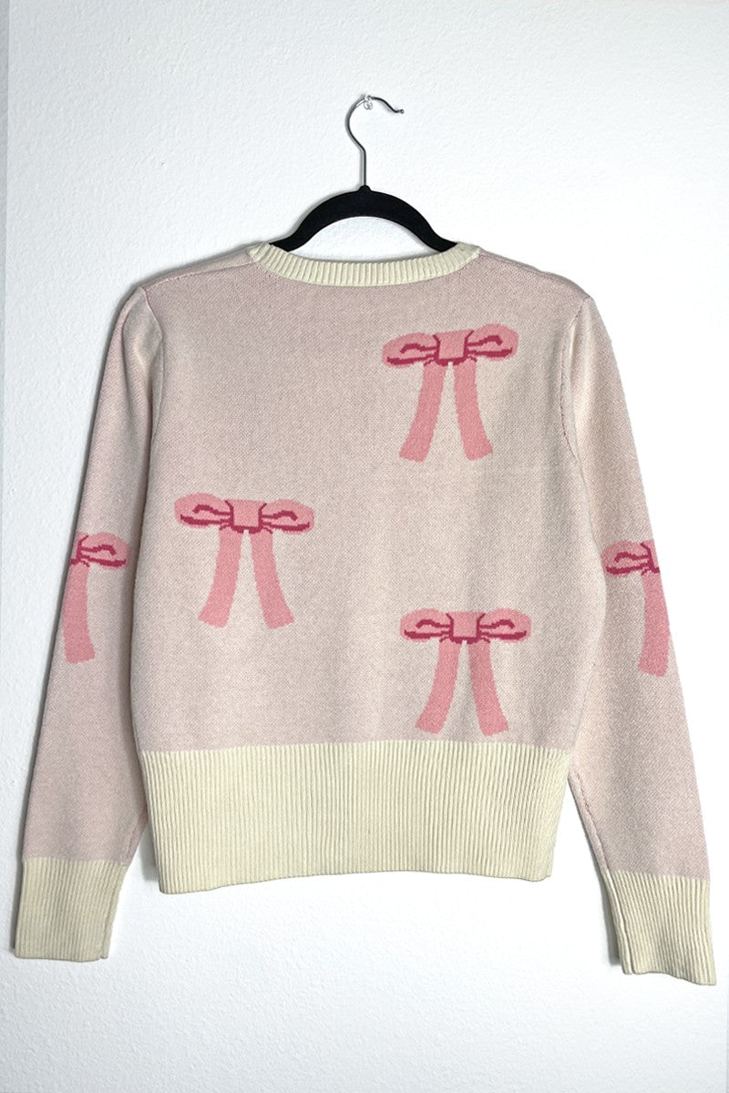 Miss Sparkling cropped knit bow cardigan featuring a soft knit fabric, front bow detail, and a stylish cropped fit.